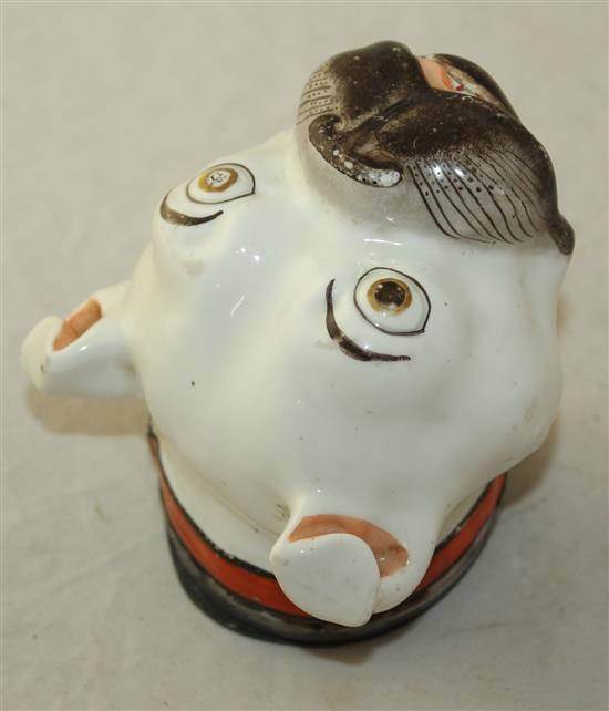 A Staffordshire porcelain bulldogs head table snuff box, c.1860, length 11.5cm, slight wear to the enamels